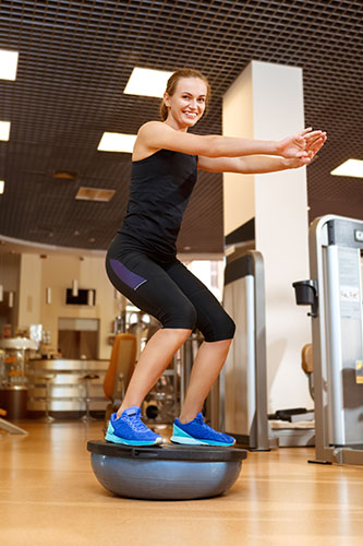 Bosu ball squats in the gym leg workout